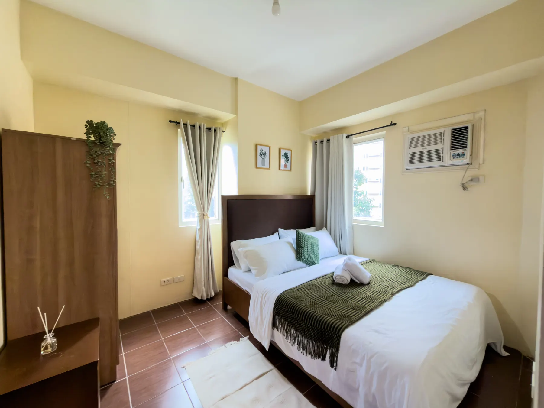 A bedroom with soft neutral tones and fresh white linens